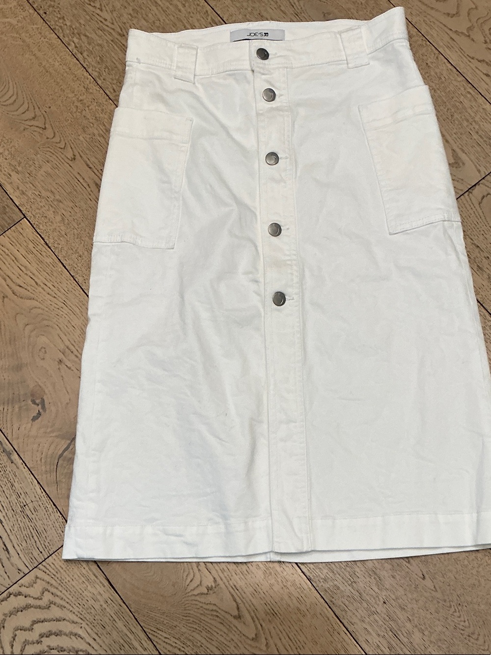 Woman’s Joe’s white denim midi skirt. Size 27. Cargo pockets. Button front. Cute